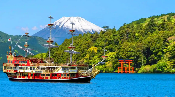 Pirate ship on a body of water with Mount Fuji in the background